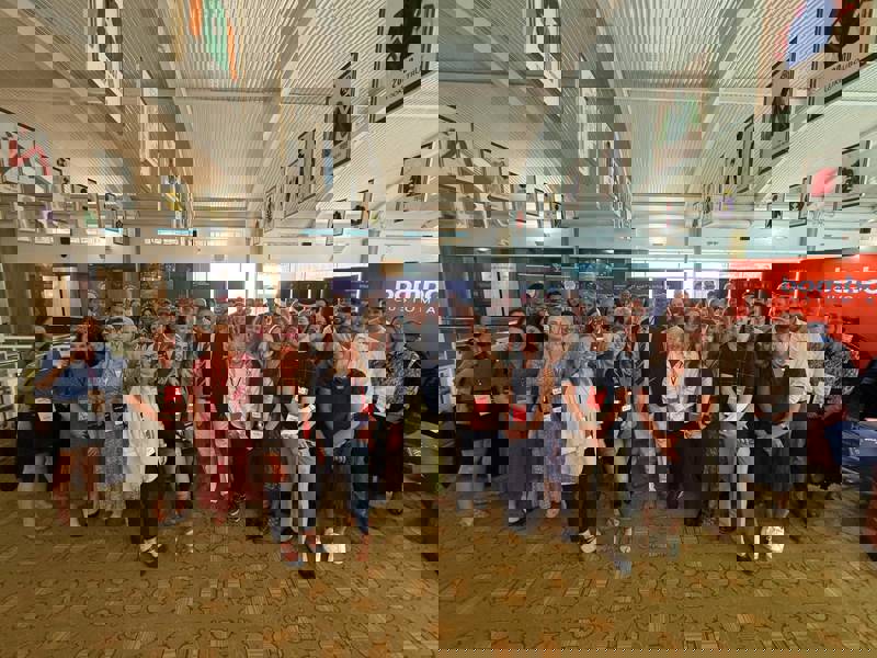 Group photo of attendees at the Business Growth Show, smiling and posing together indoors.