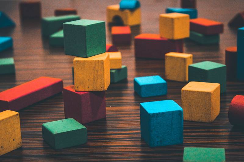 Assorted vibrant blocks in various shapes and sizes on a wooden table.