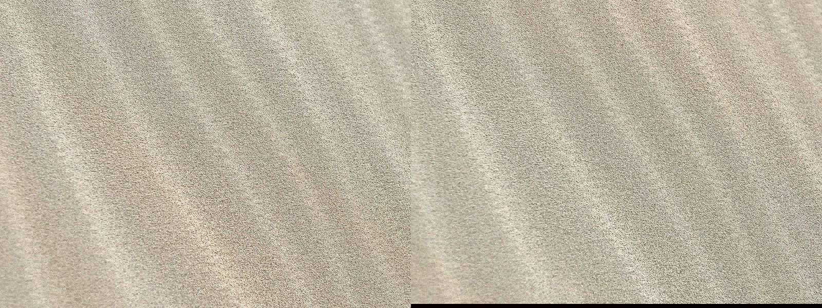 Close-up of smooth, wavy sand texture under natural light.